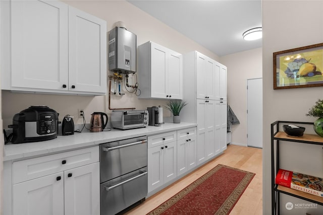 kitchen with water heater, white cabinets, and light stone counters