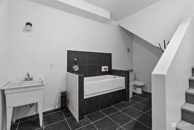 miscellaneous room featuring dark tile patterned floors and sink