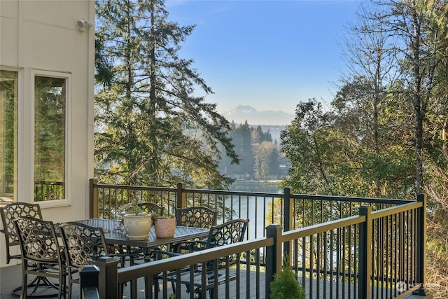 balcony featuring a water and mountain view