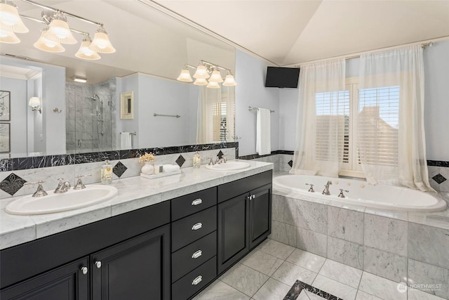 bathroom featuring tile patterned flooring, vanity, independent shower and bath, and vaulted ceiling