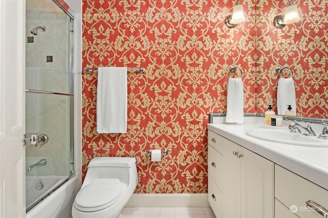 full bathroom featuring tile patterned flooring, vanity, combined bath / shower with glass door, and toilet