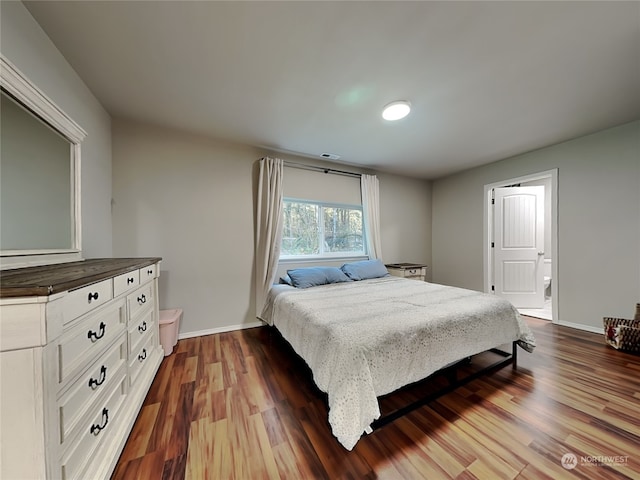 bedroom featuring hardwood / wood-style floors and ensuite bathroom