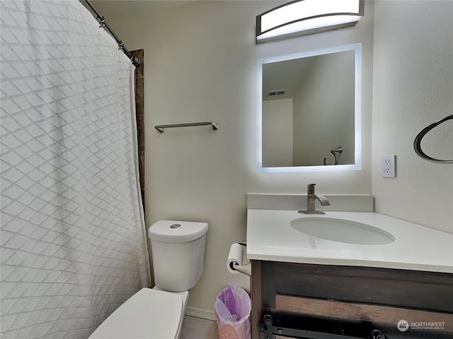 bathroom featuring vanity, a shower with curtain, and toilet