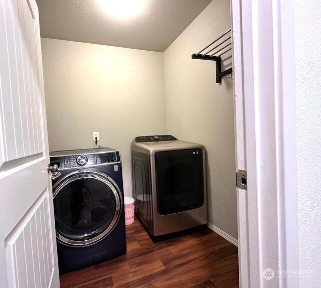 laundry room featuring dark wood-type flooring and separate washer and dryer