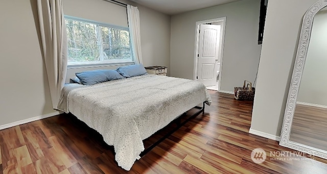 bedroom with hardwood / wood-style flooring