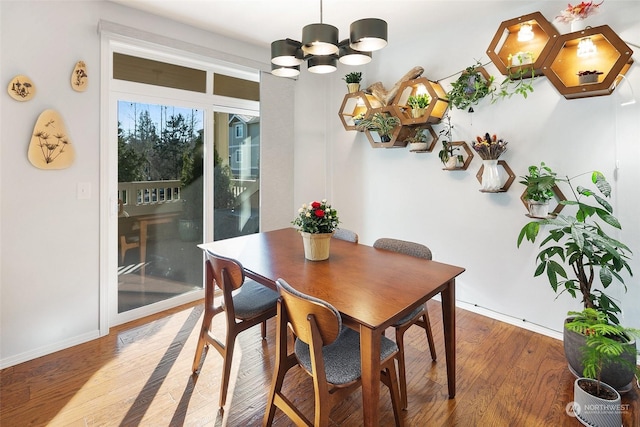 dining room featuring wood-type flooring and a chandelier