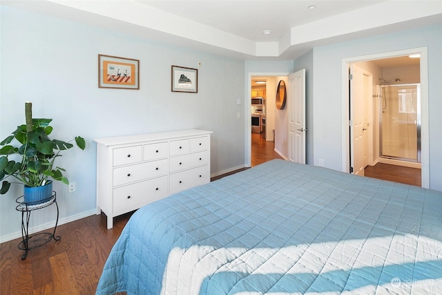 bedroom featuring dark wood-type flooring and ensuite bathroom