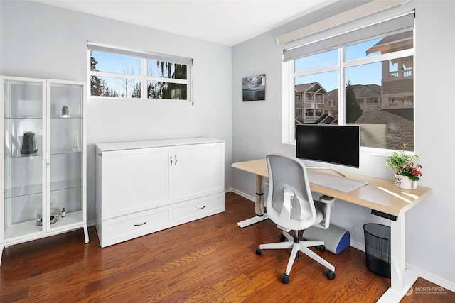 home office with dark hardwood / wood-style flooring