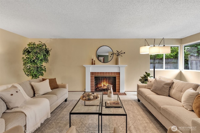 living room featuring a textured ceiling, a fireplace, and light colored carpet