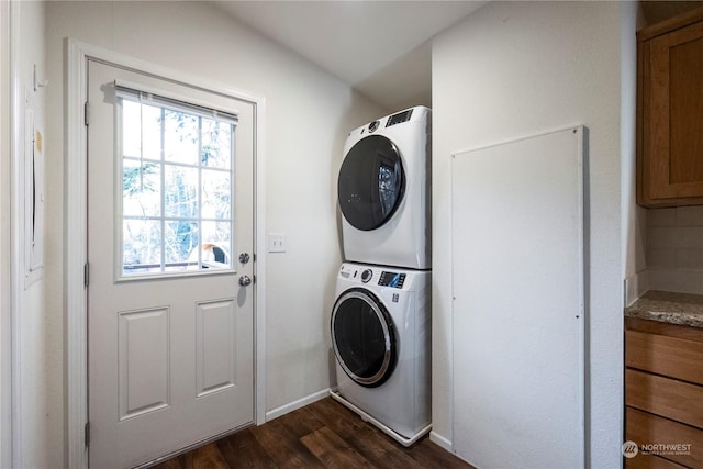 clothes washing area with dark hardwood / wood-style floors and stacked washing maching and dryer