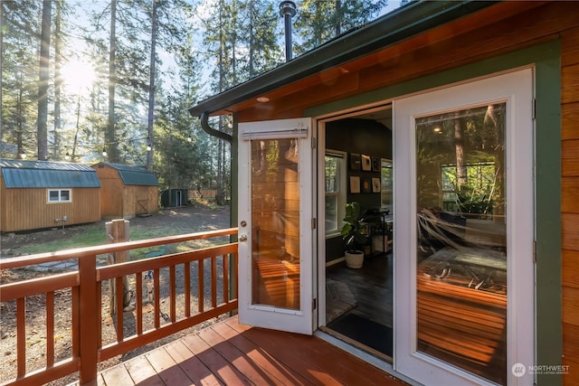 wooden terrace featuring a storage shed