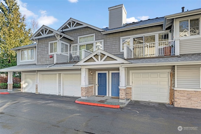 view of property featuring a balcony and a garage