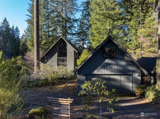 view of property exterior with a garage and an outdoor structure