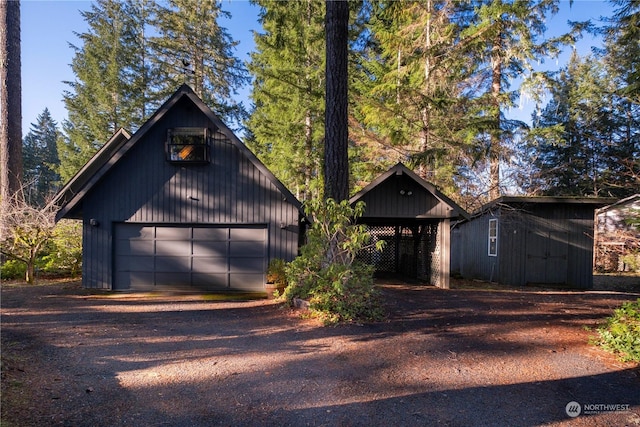 modern inspired farmhouse with a garage and an outbuilding