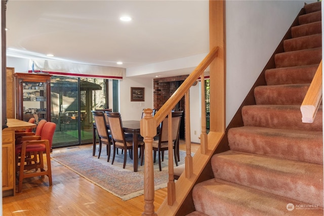 dining space with wood-type flooring