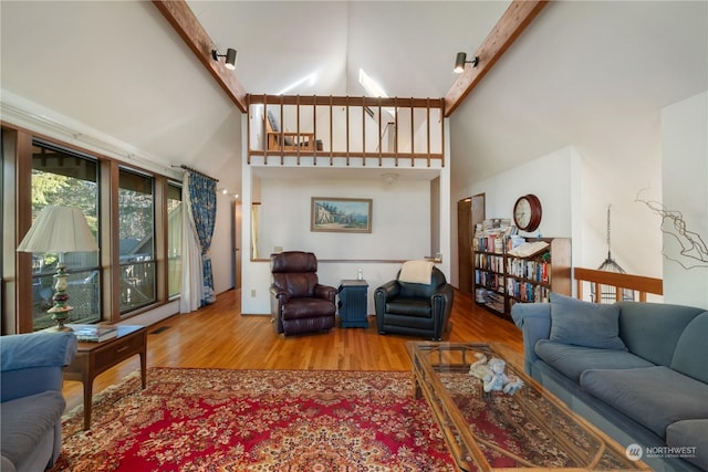 living room with hardwood / wood-style flooring and a towering ceiling