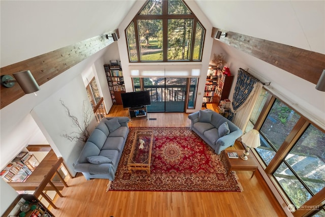 living room featuring hardwood / wood-style flooring and high vaulted ceiling