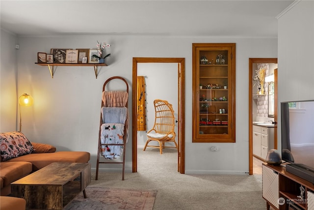 sitting room featuring light carpet and ornamental molding