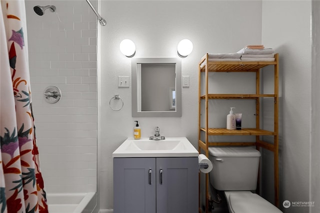 full bathroom featuring vanity, shower / bath combo with shower curtain, and toilet