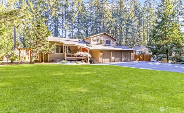 view of front of house featuring a garage and a front lawn