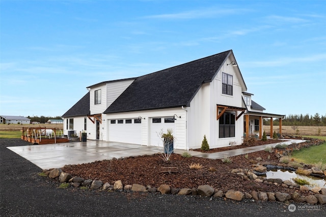 view of side of home featuring a garage and a porch