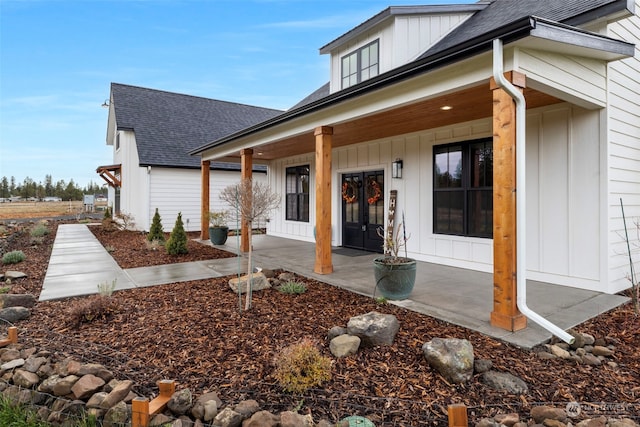 view of exterior entry featuring covered porch