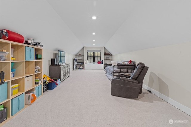 living area featuring lofted ceiling and carpet