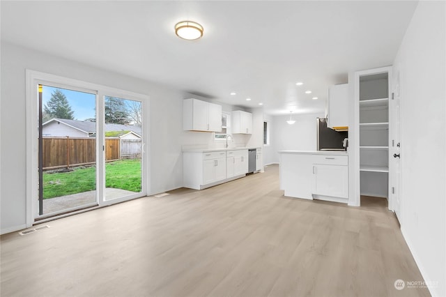 kitchen with white cabinetry, appliances with stainless steel finishes, sink, and light wood-type flooring