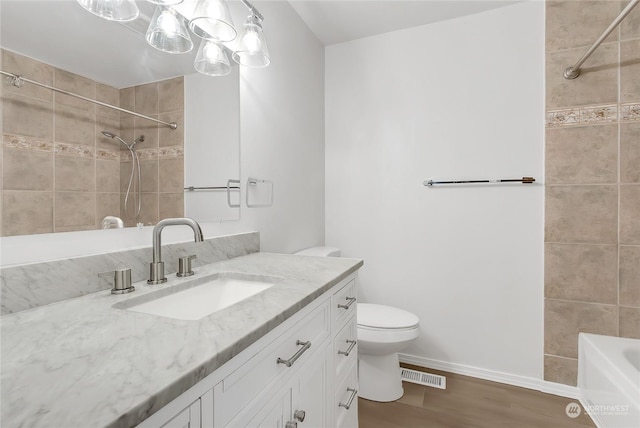 bathroom featuring vanity, hardwood / wood-style floors, and toilet