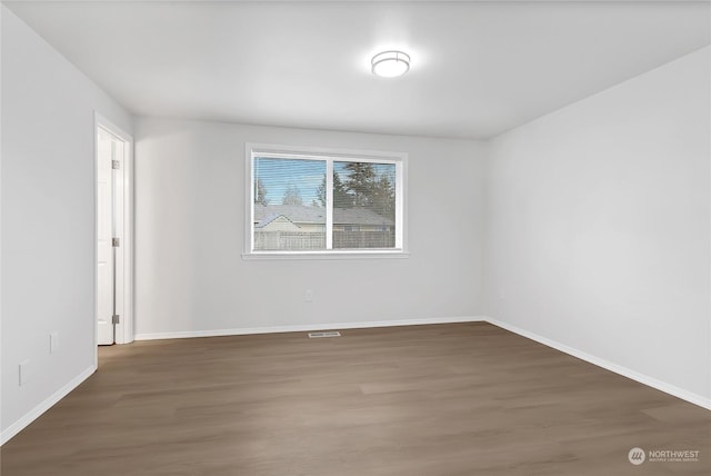 empty room with dark hardwood / wood-style floors