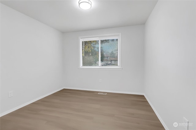 spare room featuring wood-type flooring