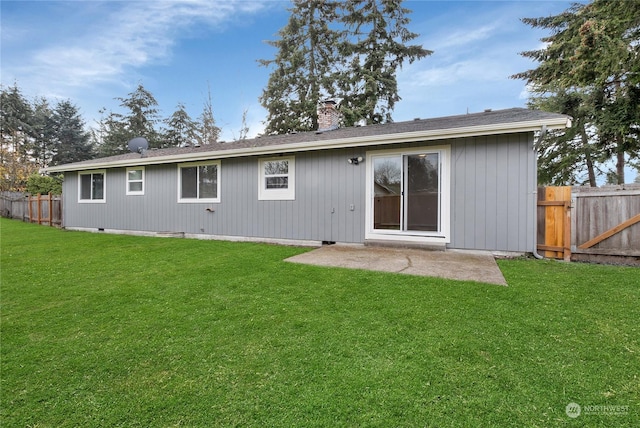 back of house with a lawn and a patio