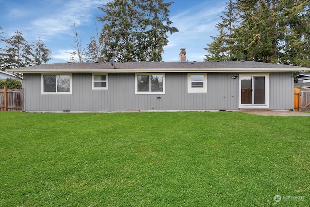 rear view of house with a lawn