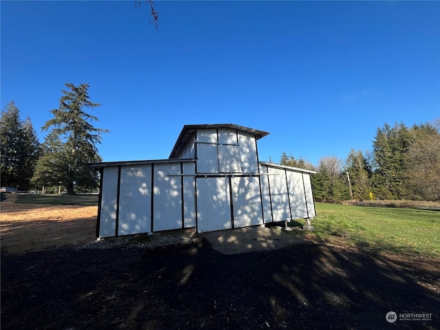 view of outbuilding featuring a lawn