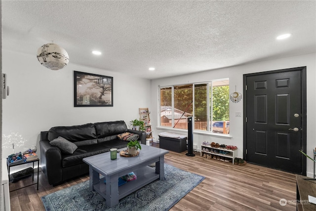 living room with hardwood / wood-style floors and a textured ceiling