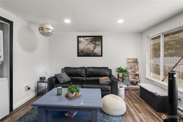 living room with plenty of natural light, dark hardwood / wood-style flooring, and a textured ceiling