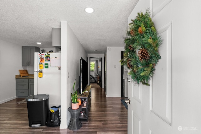 foyer entrance featuring dark hardwood / wood-style flooring and a textured ceiling