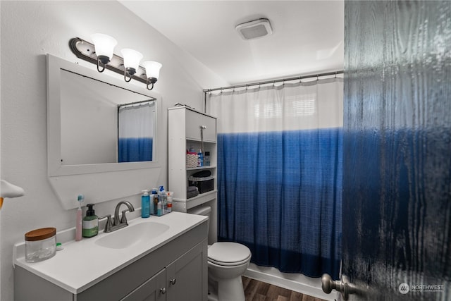 full bathroom with vanity, wood-type flooring, toilet, and shower / bath combo