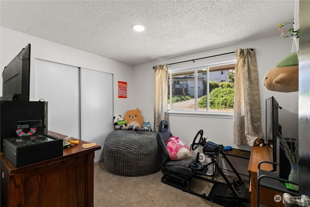 bedroom with light colored carpet, a closet, and a textured ceiling