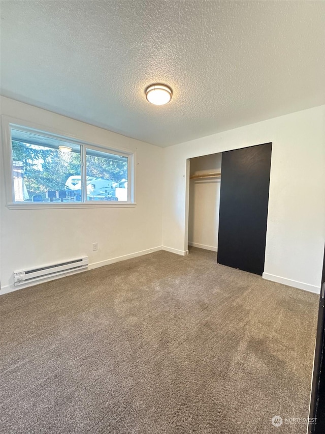 unfurnished bedroom with a baseboard radiator, carpet floors, a textured ceiling, and a closet