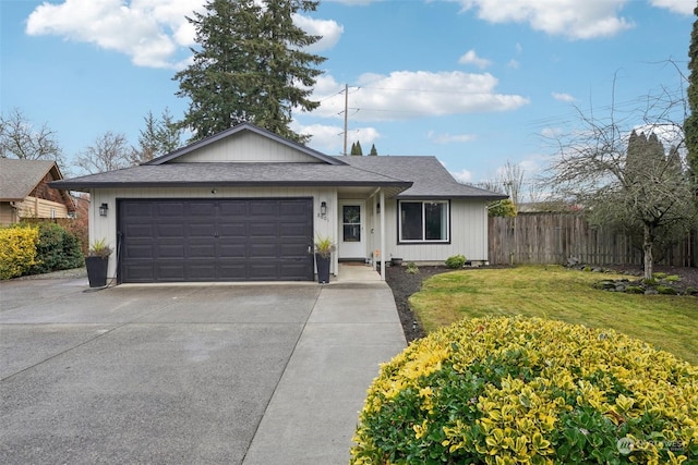 ranch-style house featuring a garage and a front yard