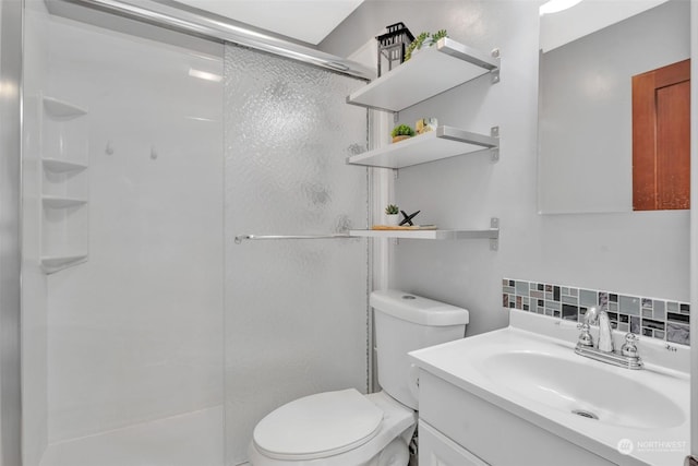 bathroom featuring vanity, a shower stall, toilet, and decorative backsplash