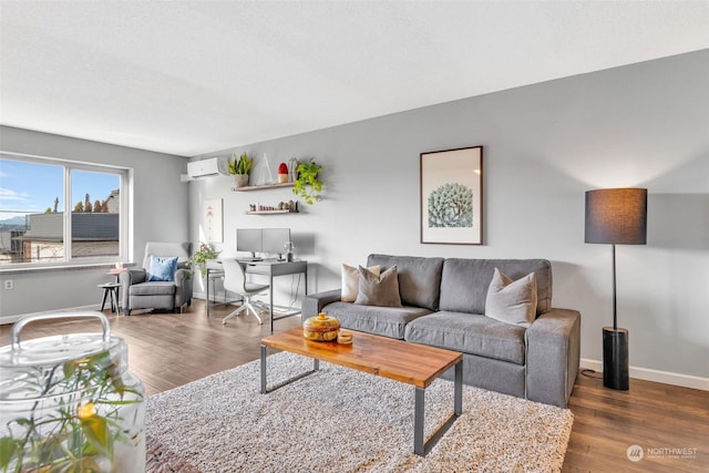 living room featuring baseboards, dark wood-style flooring, and a wall mounted air conditioner