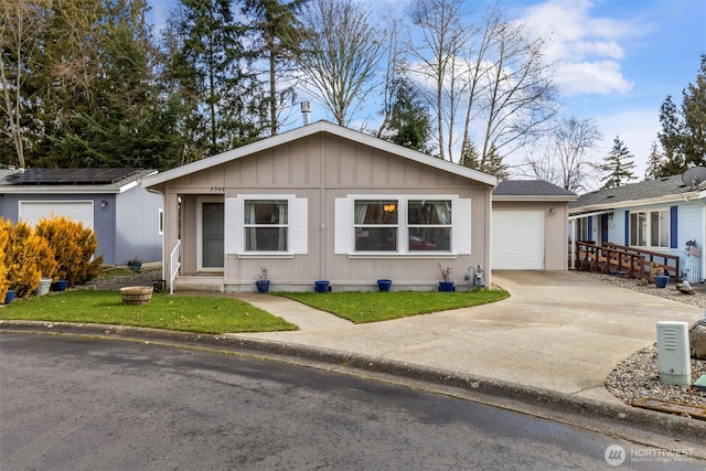 single story home with entry steps, a garage, and concrete driveway