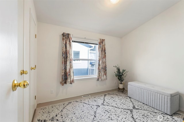 empty room with radiator, visible vents, and baseboards