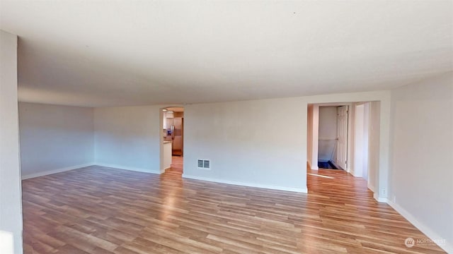 spare room featuring light hardwood / wood-style floors