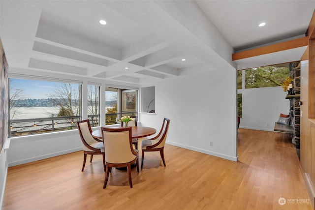 dining area with coffered ceiling, light hardwood / wood-style floors, and beamed ceiling