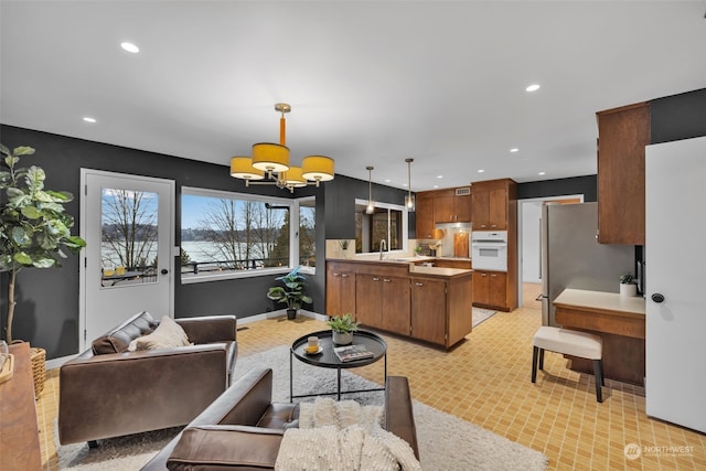 living room with sink and an inviting chandelier