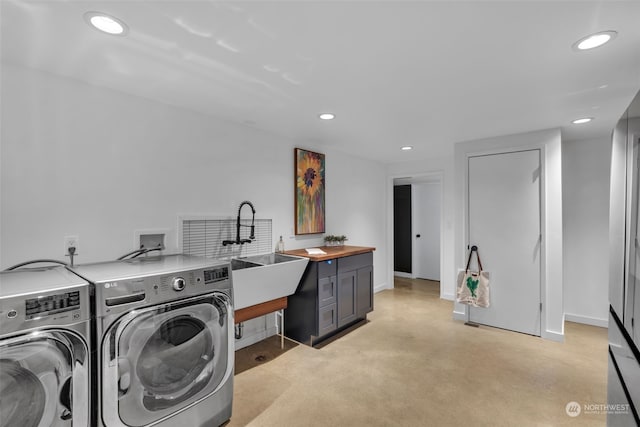 clothes washing area featuring washing machine and dryer and sink