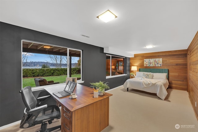 carpeted bedroom with wooden walls